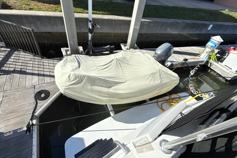 Slide: The Image of 1998 Mainship 47 Motor Yacht docked with covered equipment and coiled cables. - 9