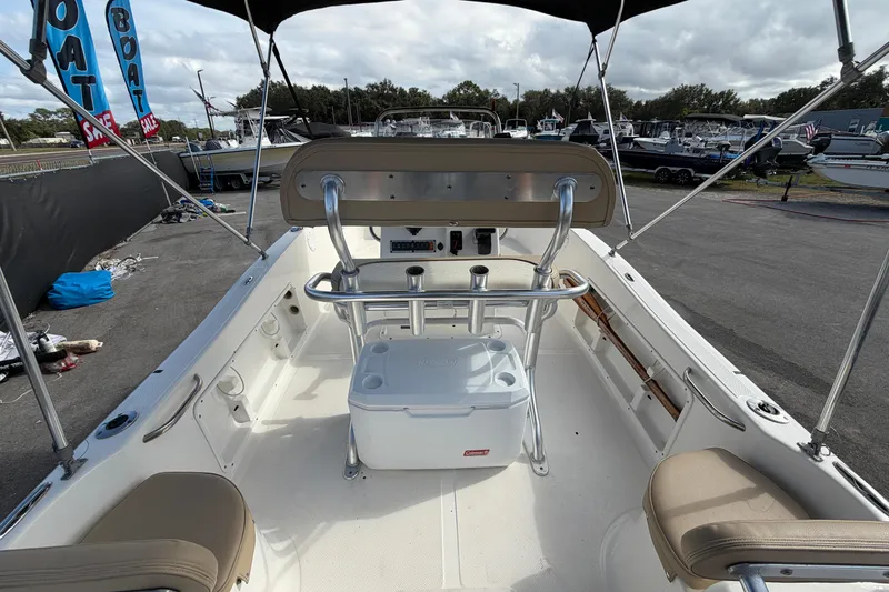 Slide: The Image of 2020 Key West 176 Sportsman CC boat interior with seating and cooler, displayed at a sale event. - 14