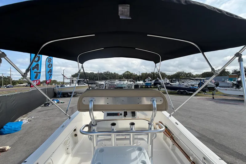 Slide: The Image of 2020 Key West 176 Sportsman CC boat with canopy, displayed at a dealership. - 15