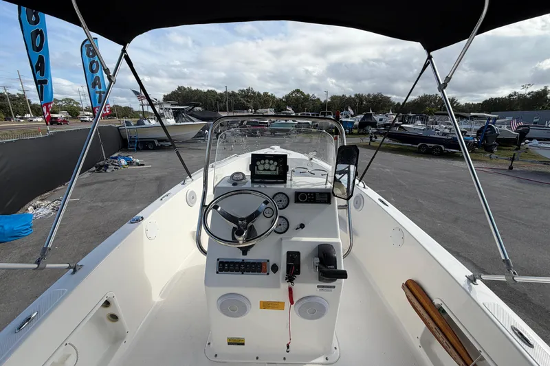 Slide: The Image of 2020 Key West 176 Sportsman CC boat interior with steering console and canopy. - 19