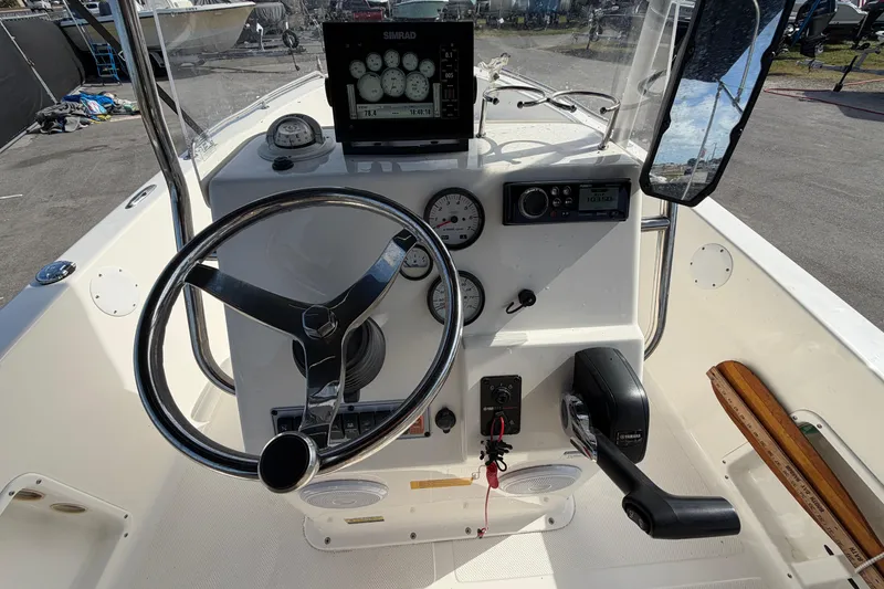 Slide: The Image of 2020 Key West 176 Sportsman CC boat dashboard with steering wheel and controls. - 21