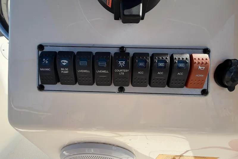 Slide: The Image of Control panel of a 2020 Key West 176 Sportsman CC boat with labeled switches. - 26