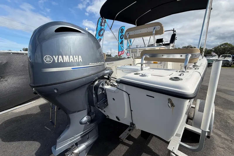 Slide: The Image of 2020 Key West 176 Sportsman CC boat with Yamaha outboard motor, parked outdoors. - 3