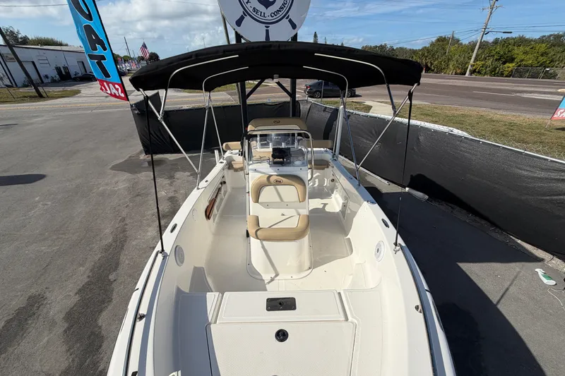 Slide: The Image of 2020 Key West 176 Sportsman CC boat with canopy, parked outdoors. - 37