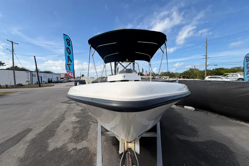 Slide: The Image of 2020 Key West 176 Sportsman CC boat on trailer under blue sky. - 4