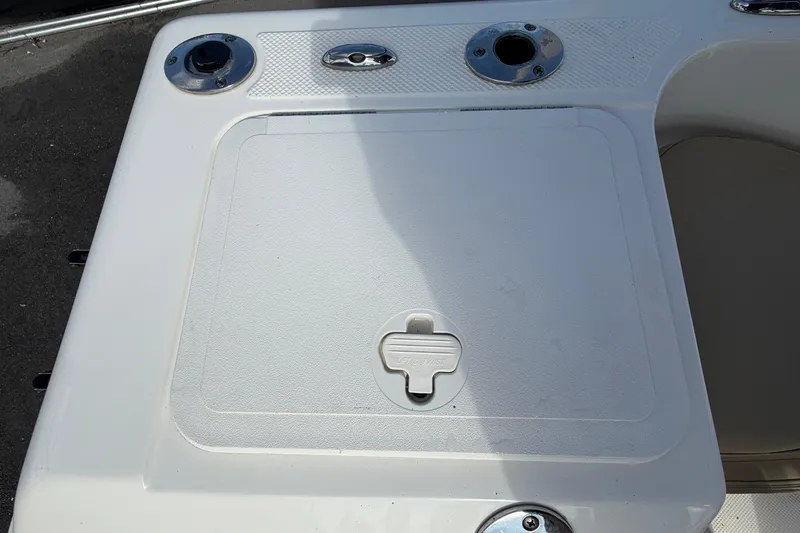 Slide: The Image of Key West 176 Sportsman CC 2020 boat deck with storage compartment and rod holders. - 48