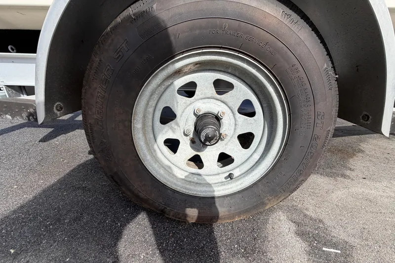 Slide: The Image of Trailer wheel of a 2020 Key West 176 Sportsman CC on asphalt. - 52