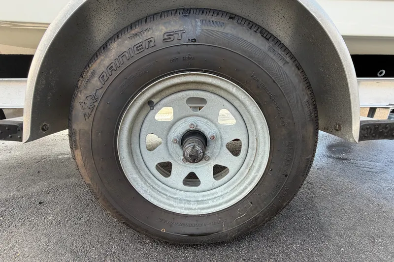Slide: The Image of Trailer wheel of a 2020 Key West 176 Sportsman CC on wet pavement. - 53