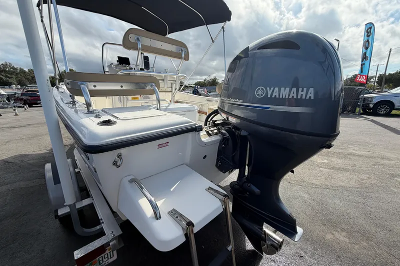 Slide: The Image of 2020 Key West 176 Sportsman CC boat with Yamaha outboard motor, parked outdoors. - 9