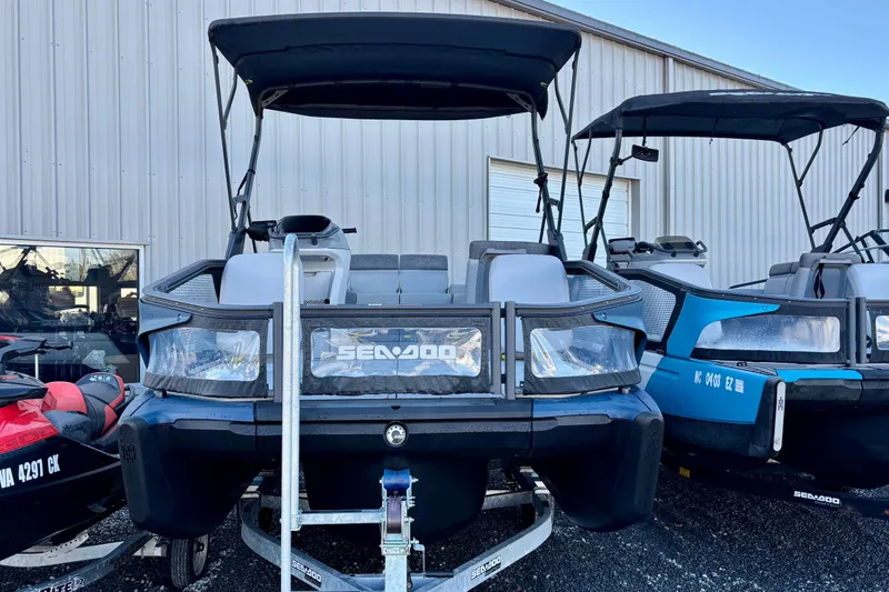 Slide: The Image of 2024 Sea-Doo Switch Sport 18 pontoon boat with canopy, parked on trailer. - 13