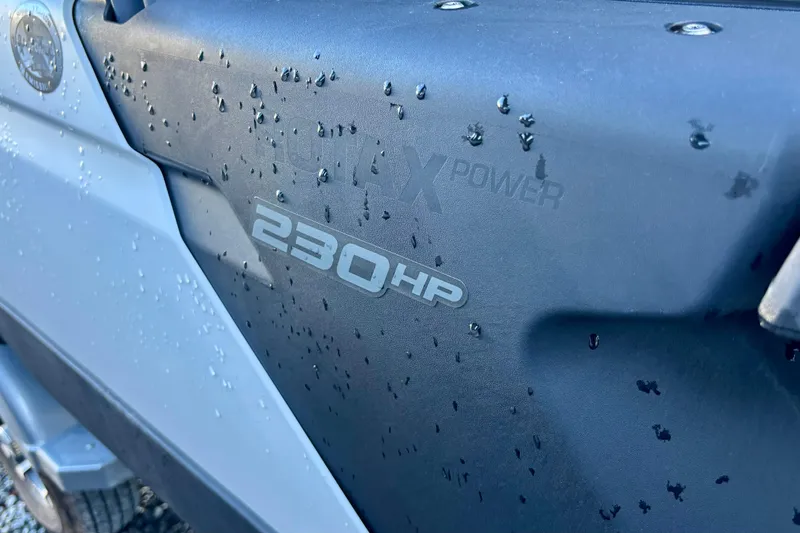 Slide: The Image of Close-up of 2024 Sea-Doo Switch Sport 18, showcasing 230 HP engine detail. - 2