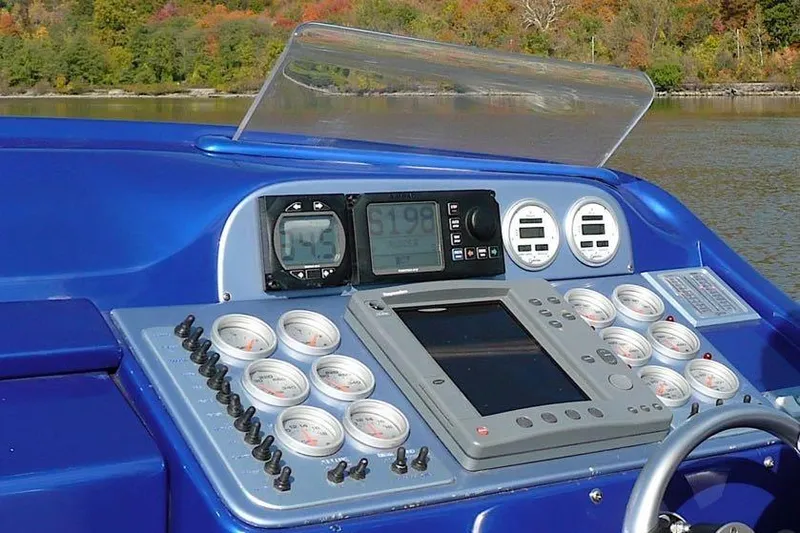 Slide: The Image of Control panel of a 2001 Nor-Tech 38 Super Vee boat with gauges and displays. - 5