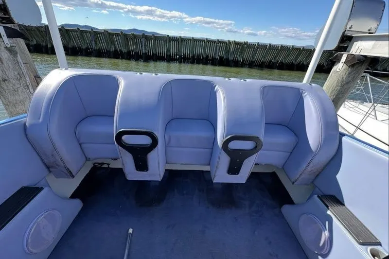 Slide: The Image of 2001 Nor-Tech 38 Super Vee boat interior with blue seating and waterfront view. - 8