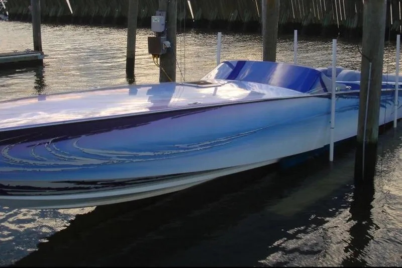 The Image of 2001 Nor-Tech 38 Super Vee speedboat docked on calm water. - 0