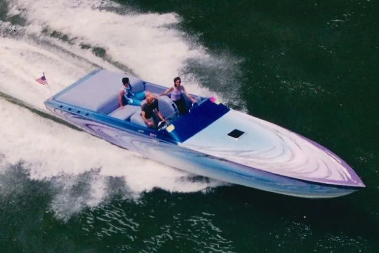 Slide: The Image of 2001 Nor-Tech 38 Super Vee speedboat cruising on water with passengers. - 3