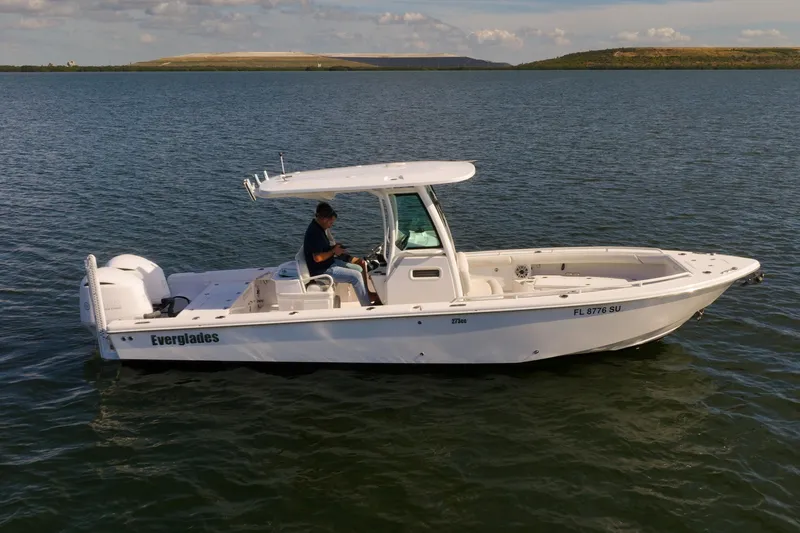 The Image of 2021 Everglades 273 Center Console boat on calm water, side view. - 0