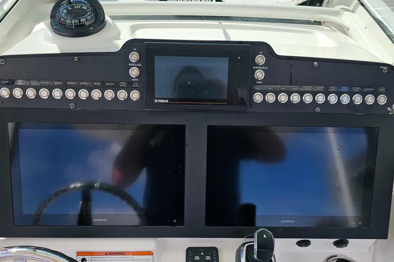 Slide: The Image of 2021 Everglades 273 Center Console dashboard with Garmin displays and Yamaha controls. - 14
