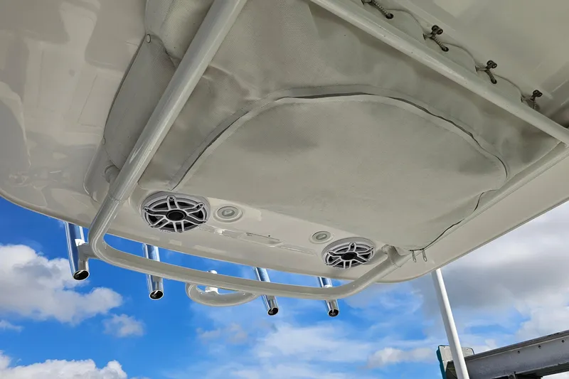 Slide: The Image of 2021 Everglades 273 Center Console boat roof with speakers against blue sky. - 21