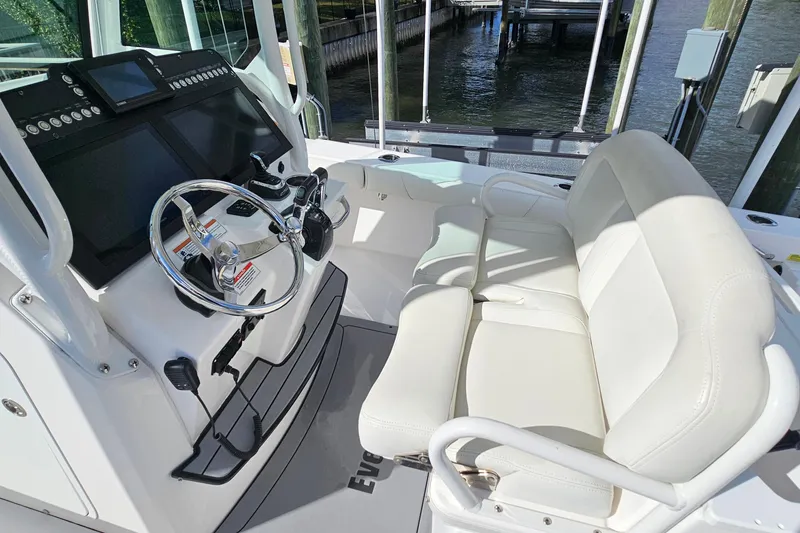 Slide: The Image of 2021 Everglades 273 Center Console boat interior with steering wheel and seating. - 23