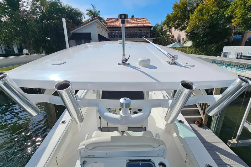 Slide: The Image of 2021 Everglades 273 Center Console boat docked, featuring rod holders and sleek design. - 25