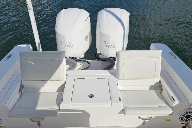 Slide: The Image of 2021 Everglades 273 Center Console with twin Yamaha 300 engines and white seating. - 27