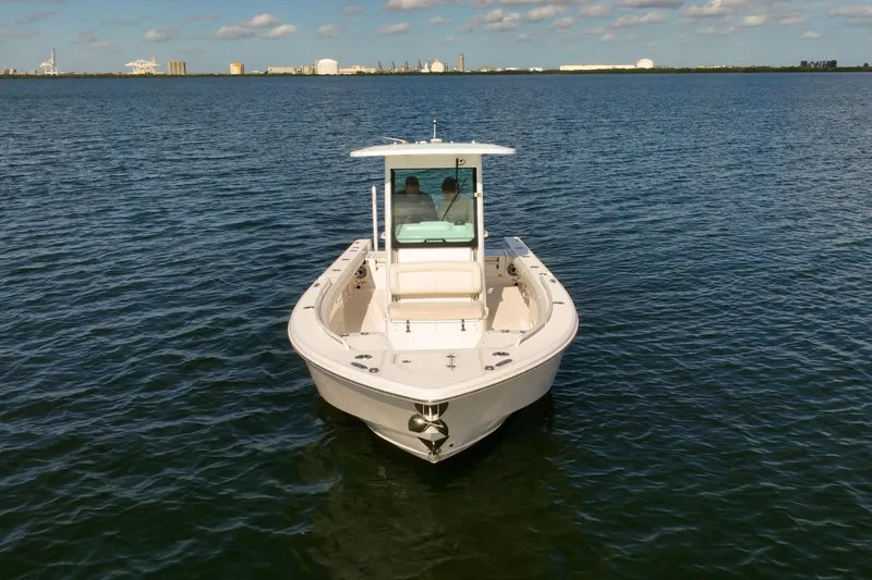 Slide: The Image of 2021 Everglades 273 Center Console boat on calm water, clear sky background. - 3