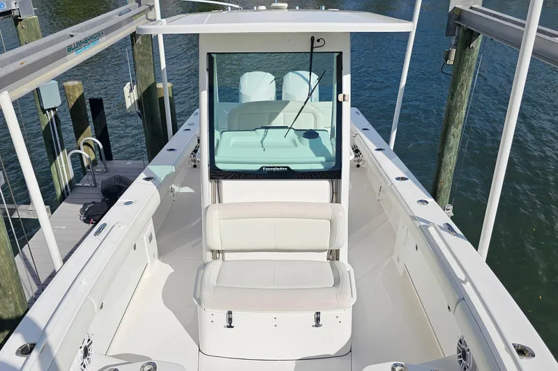 Slide: The Image of 2021 Everglades 273 Center Console boat docked, showcasing spacious seating and sleek design. - 35