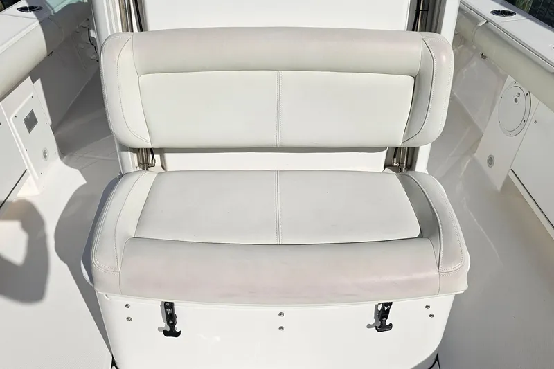 Slide: The Image of 2021 Everglades 273 Center Console boat seat, white upholstery, sleek design. - 36