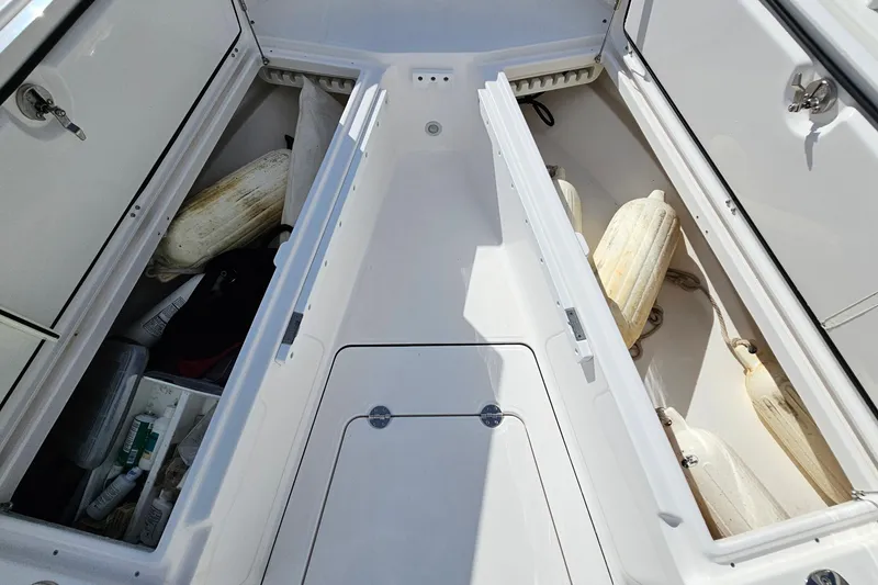 Slide: The Image of Storage compartments on a 2021 Everglades 273 Center Console boat, containing fenders and supplies. - 38