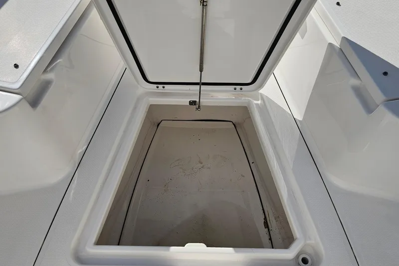 Slide: The Image of Open storage compartment on 2021 Everglades 273 Center Console boat. - 40