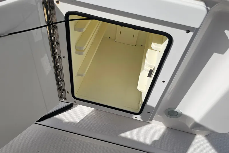 Slide: The Image of Open storage compartment on 2021 Everglades 273 Center Console boat. - 42