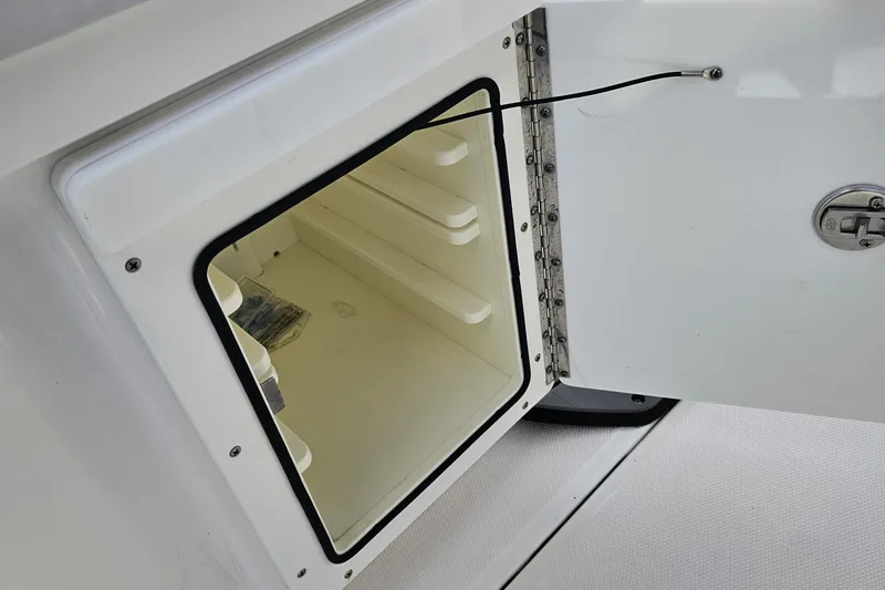Slide: The Image of Open storage compartment on 2021 Everglades 273 Center Console boat. - 43
