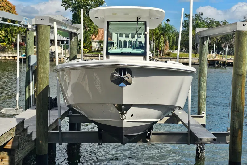 Slide: The Image of 2021 Everglades 273 Center Console boat on lift at marina dock. - 51