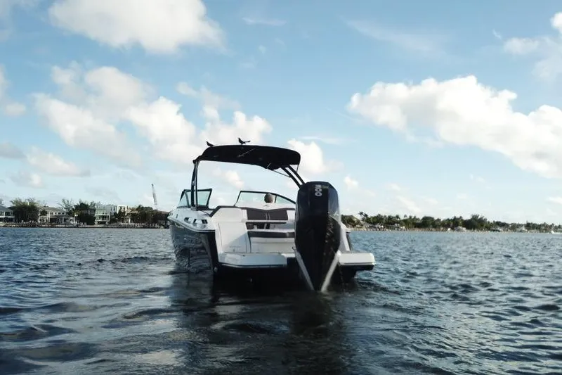 Slide: The Image of 2022 Monterey 255SS Super Sport boat on water under blue sky. - 10
