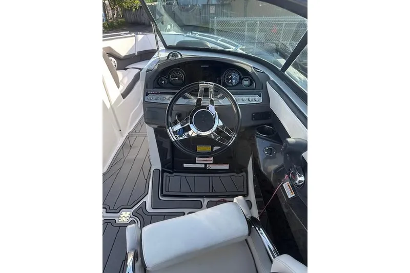 Slide: The Image of 2022 Monterey 255SS Super Sport boat cockpit with modern steering and dashboard controls. - 12