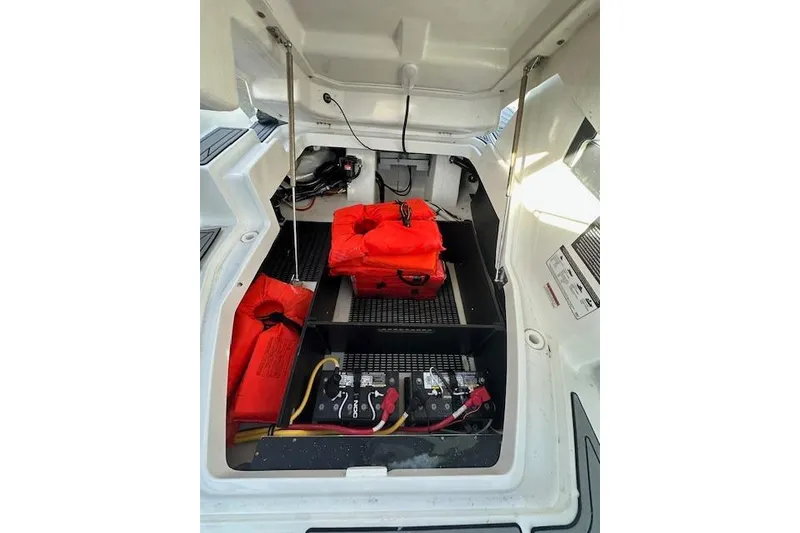 Slide: The Image of 2022 Monterey 255SS Super Sport boat storage with life jackets and battery compartment. - 18