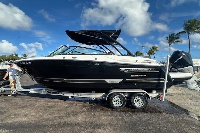 Slide: The Image of 2022 Monterey 255SS Super Sport boat on trailer, parked outdoors under blue sky. - 19