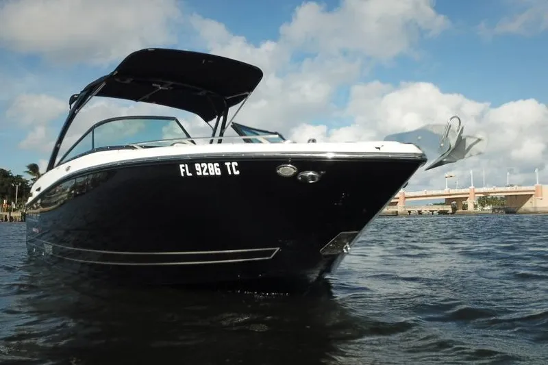 Slide: The Image of 2022 Monterey 255SS Super Sport boat on water, under a cloudy sky. - 6