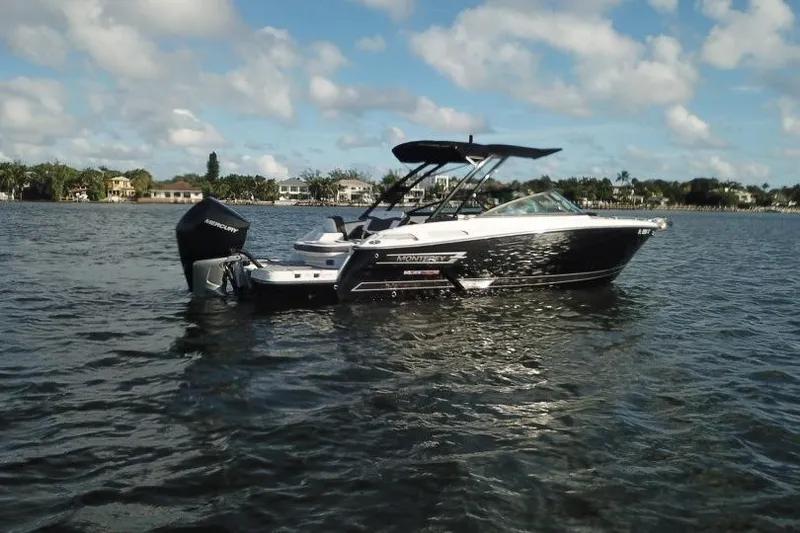 Slide: The Image of 2022 Monterey 255SS Super Sport boat on calm water under a partly cloudy sky. - 7