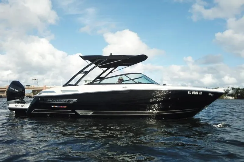 Slide: The Image of 2022 Monterey 255SS Super Sport boat on water under blue sky. - 9
