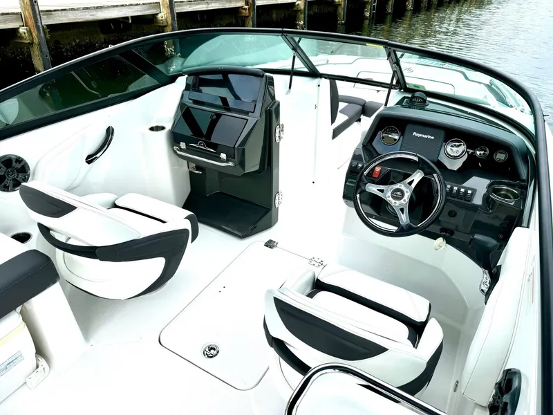 Slide: The Image of 2018 Monterey M-45 boat interior with sleek black and white seating and modern dashboard. - 3