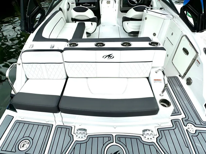 Slide: The Image of 2018 Monterey M-45 boat interior with white and black seating, cup holders, and non-slip flooring. - 8