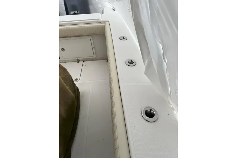 Slide: The Image of 2016 Southport 272 FE boat interior with rod holders and storage compartment. - 10