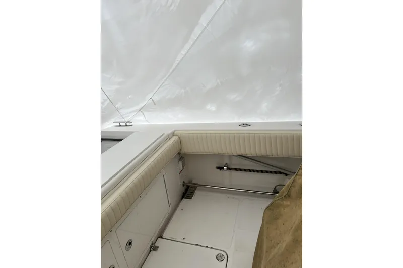 Slide: The Image of 2016 Southport 272 FE boat interior with white seating and covered deck. - 11