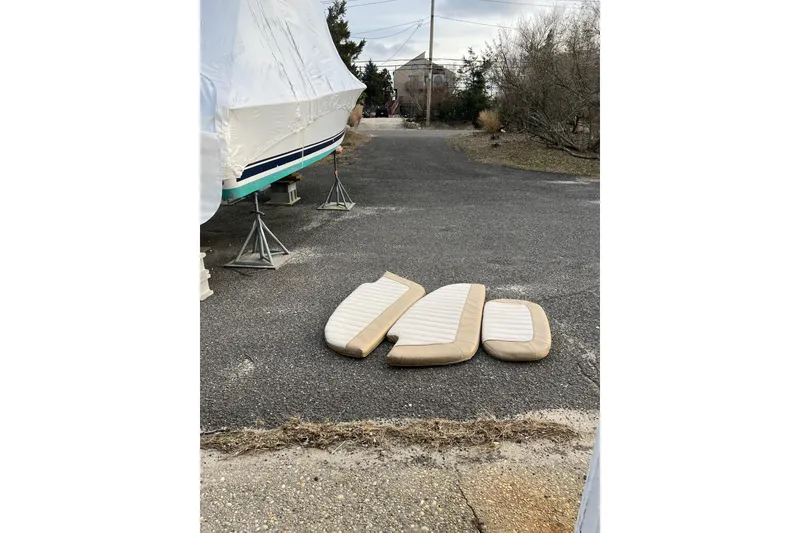 Slide: The Image of Covered 2016 Southport 272 FE boat with cushions on pavement. - 14