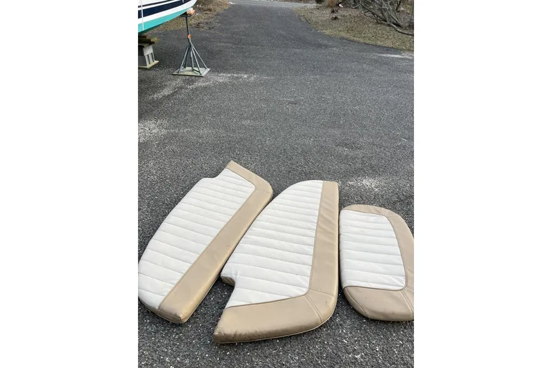 Slide: The Image of Cushions from a 2016 Southport 272 FE boat on asphalt near a boat stand. - 15