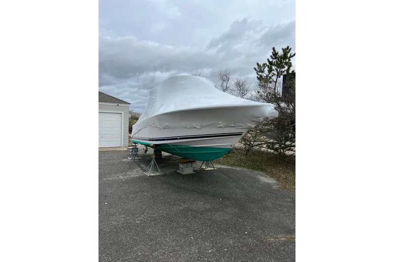 Slide: The Image of Covered 2016 Southport 272 FE boat on stands in driveway. - 2