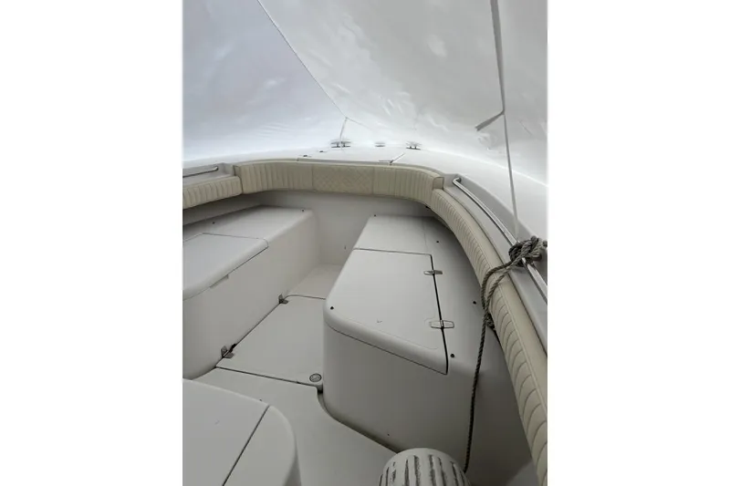Slide: The Image of 2016 Southport 272 FE boat interior with cushioned seating and storage compartments. - 4