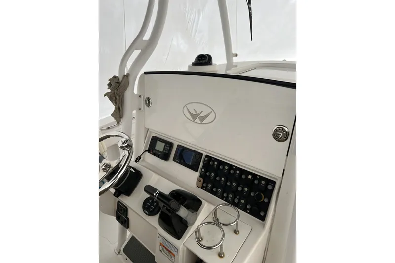 Slide: The Image of 2016 Southport 272 FE boat dashboard with steering wheel and control panel. - 8