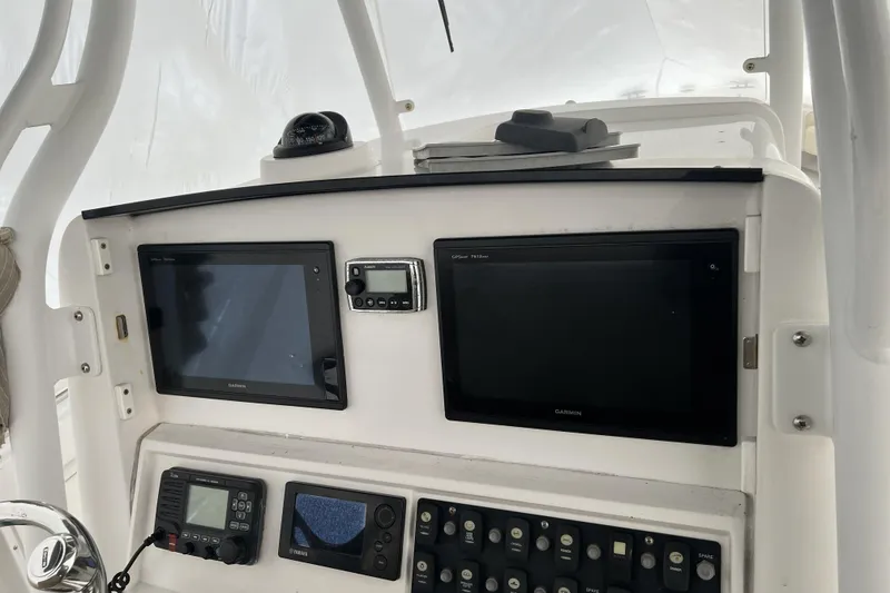 Slide: The Image of 2016 Southport 272 FE boat dashboard with Garmin displays and control panel. - 9